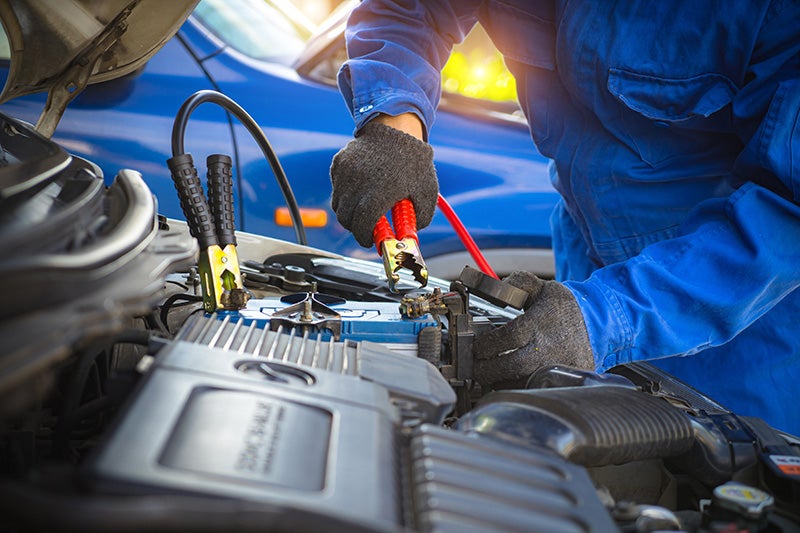 Service Technician Charging Car Battery 